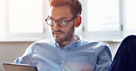 HEC-YoungManWithGlassesOnComputer-272×143-compressed Young Man With Glasses On Computer